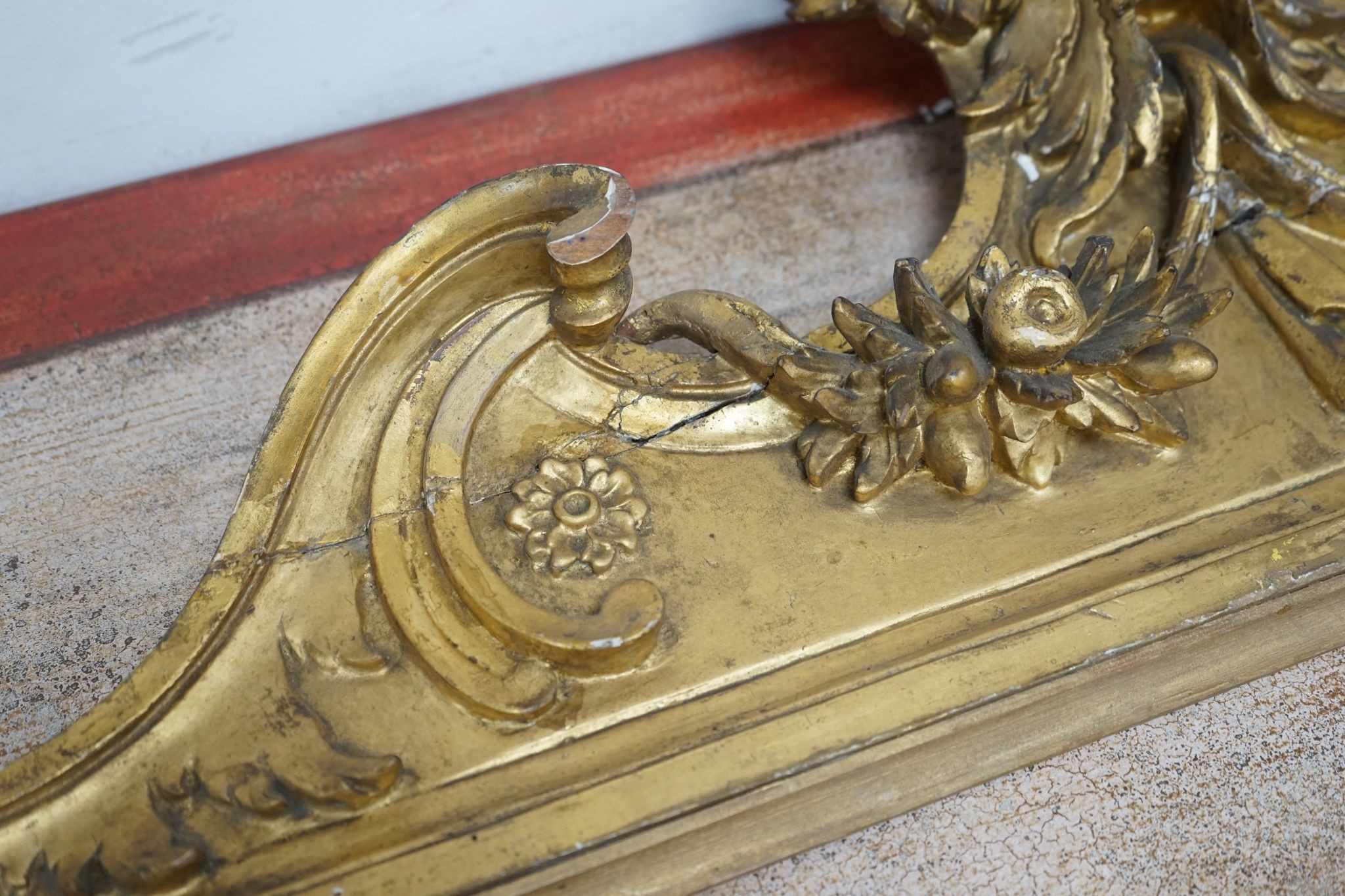 A 19th century carved giltwood pediment, width 142cm